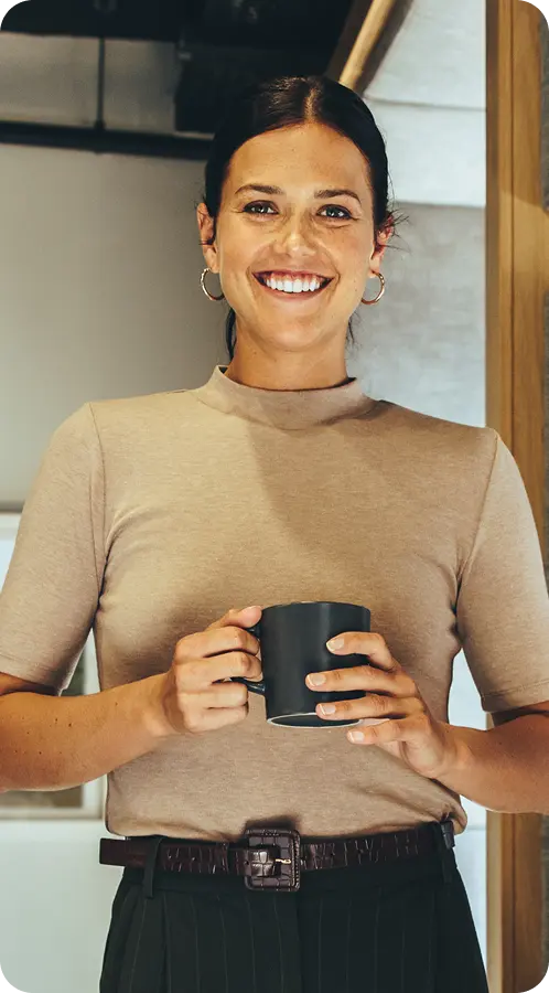 Smiling woman holding a coffee mug